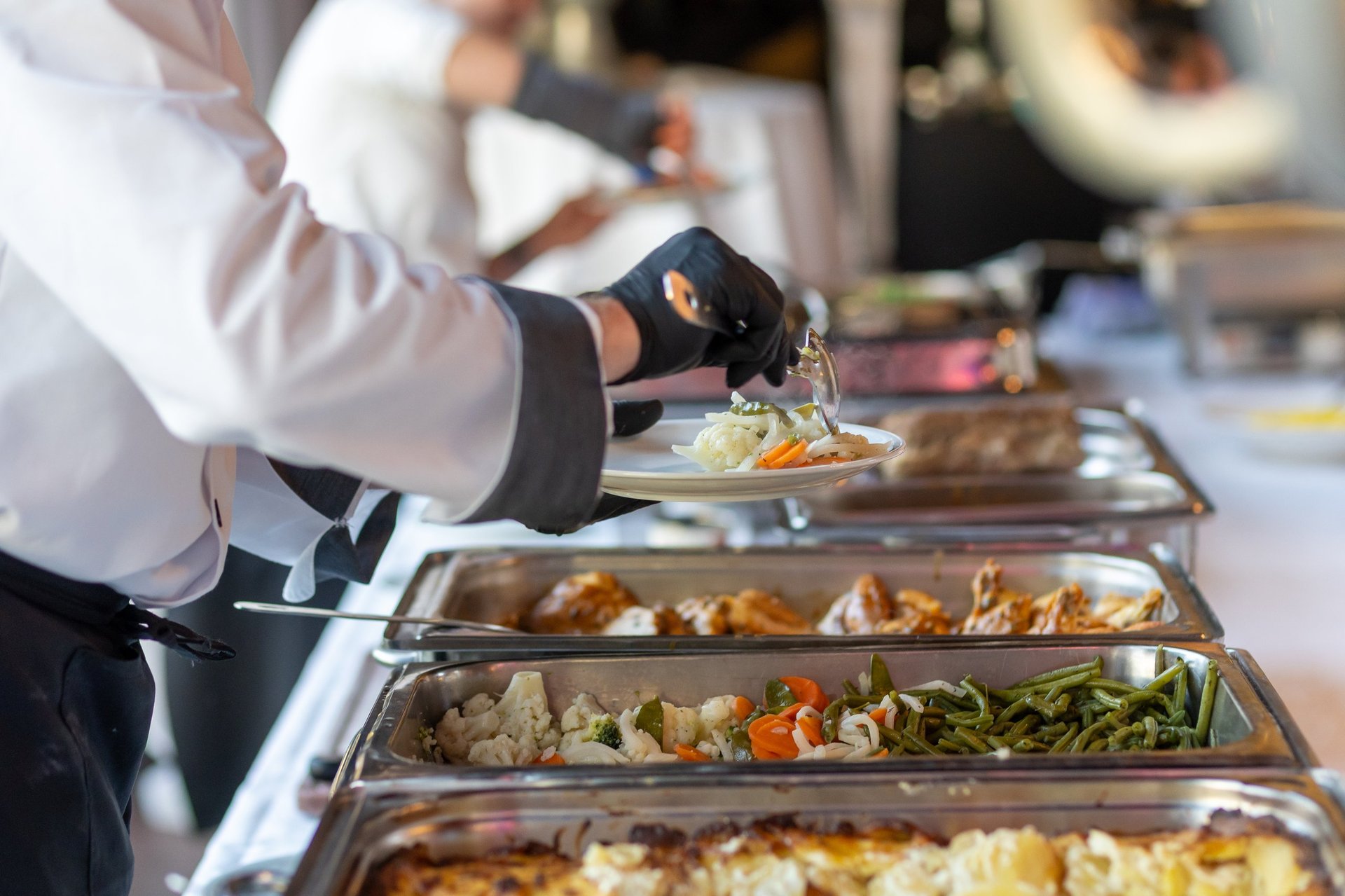 Catering staff serving a gourmet buffet