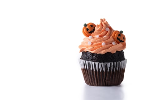 Halloween cupcakes with orange buttercream and pumpkin decoration