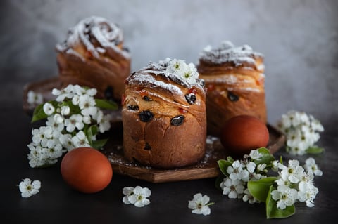 Traditional Easter cakes with flowers and eggs on a rustic background