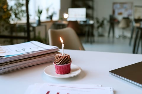 Chocolate cupcake with single lit birthday candle
