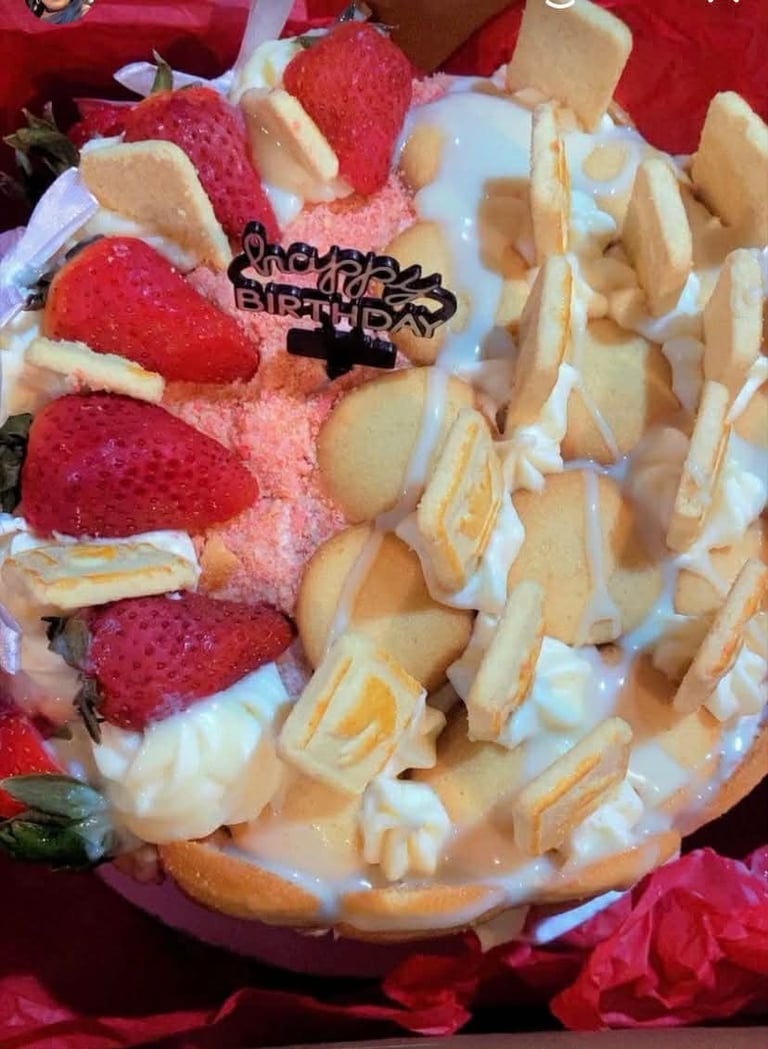 Strawberry shortcake decorated with fresh strawberries, wafer cookies, whipped cream, and a Happy Everday message on a red background